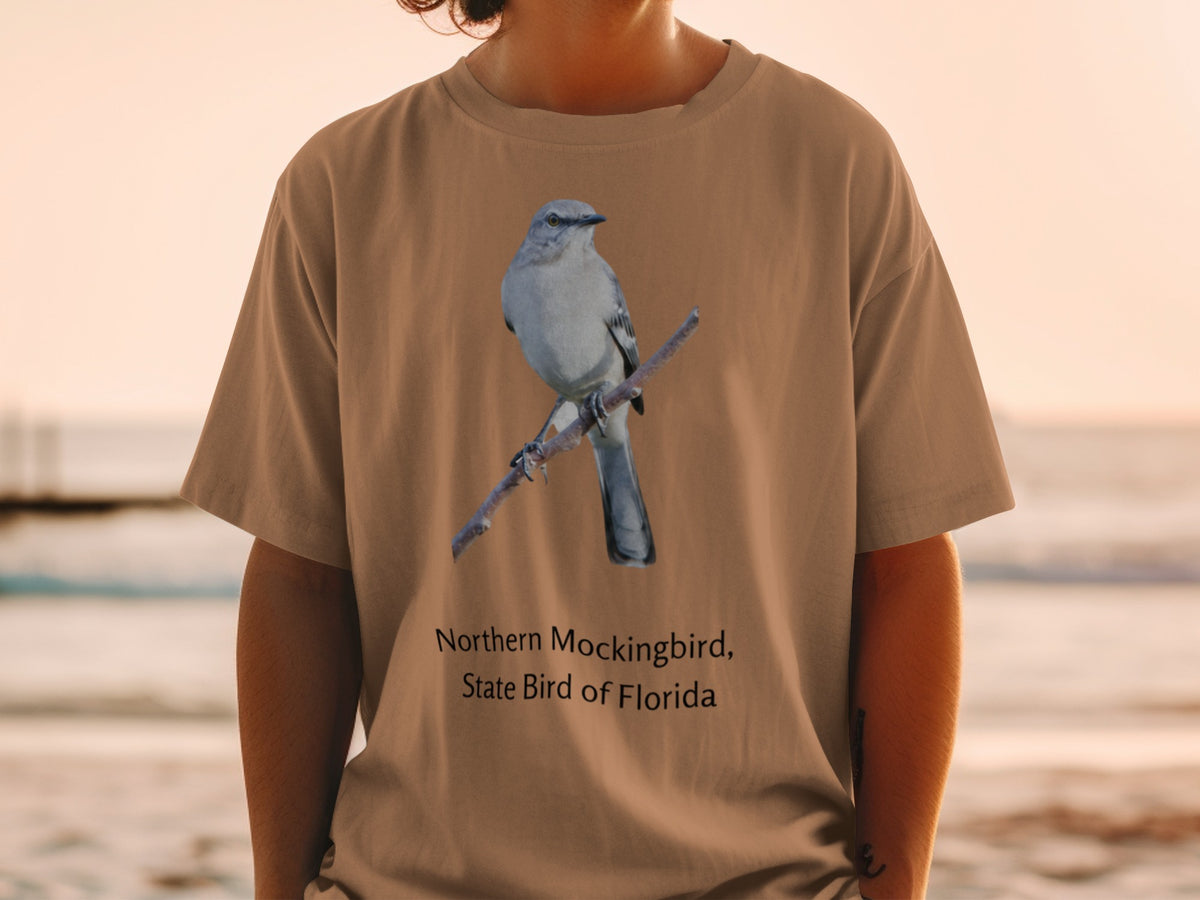 Northern Mockingbird, State Bird of Florida graphic on a tan t-shirt.