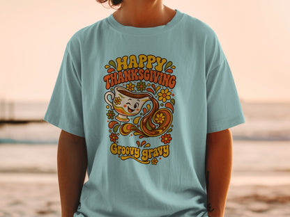 Light blue t-shirt with "Happy Thanksgiving Groovy Gravy" and smiling gravy boat graphic.