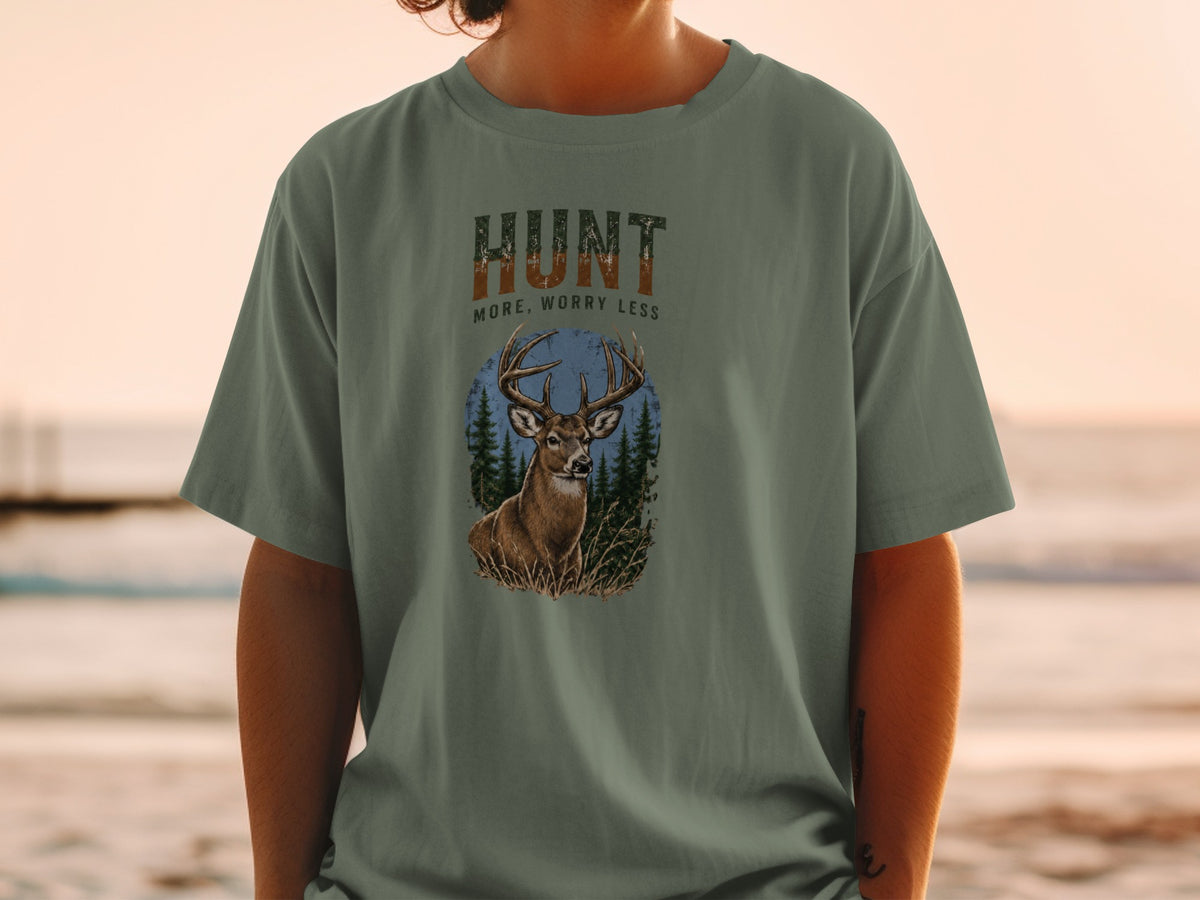 T-shirt graphic with text "HUNT MORE, WORRY LESS" and a deer in a forest scene.