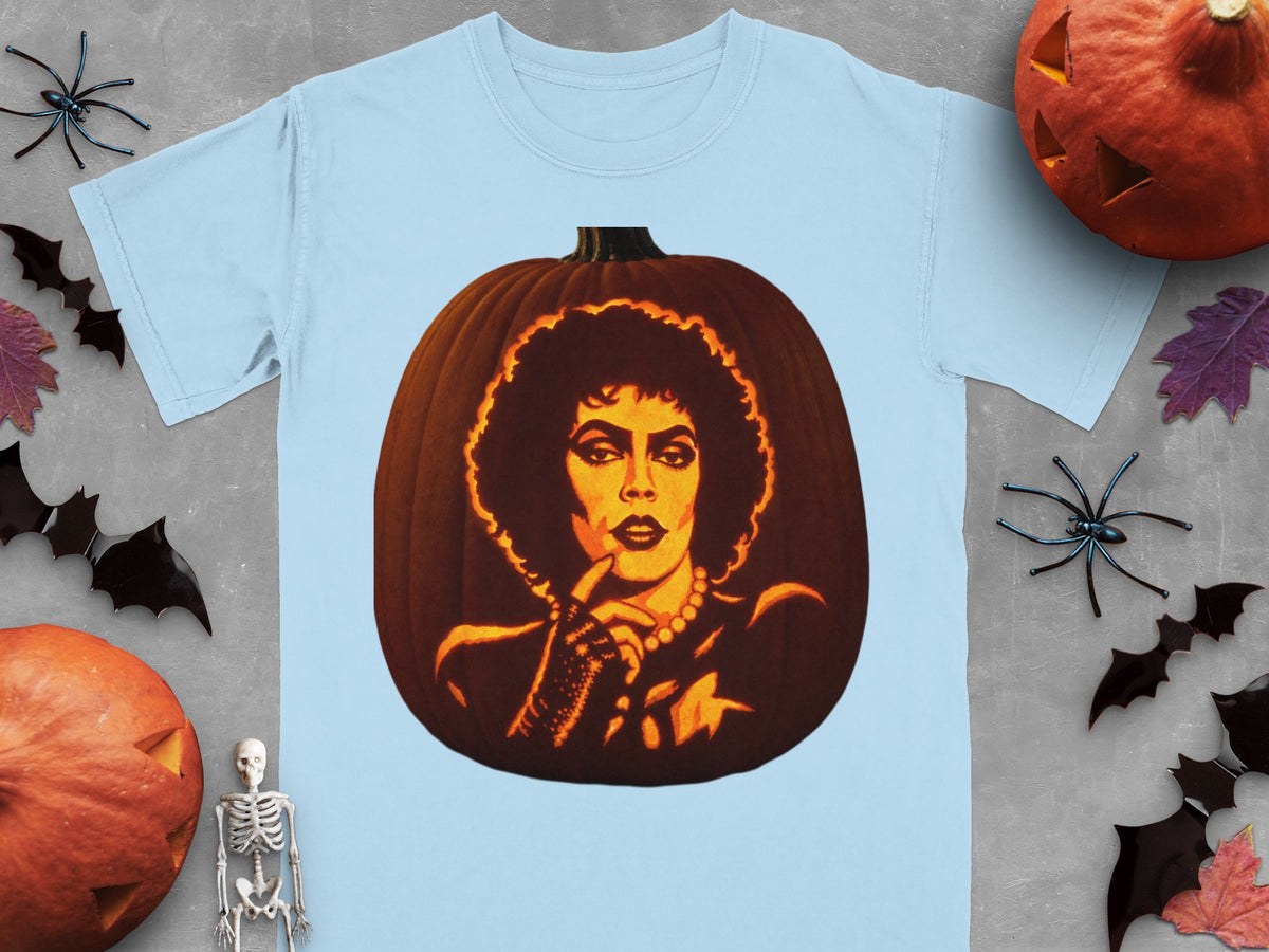 Light blue t-shirt featuring a carved pumpkin graphic of Frank-N-Furter, surrounded by Halloween decorations on gray background.