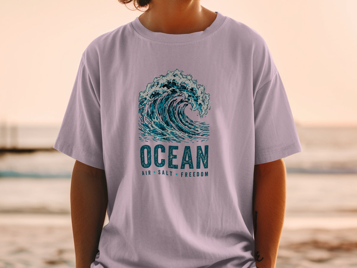 T-shirt with a crashing wave graphic and "Ocean Air Salt Freedom" text.