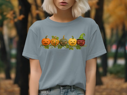 Five carved pumpkins with happy faces arranged on a vine.