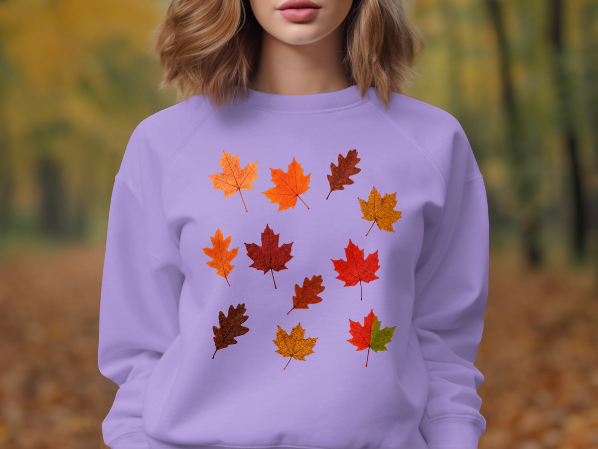 Purple sweatshirt with a scattered pattern of autumn leaves in various colors.