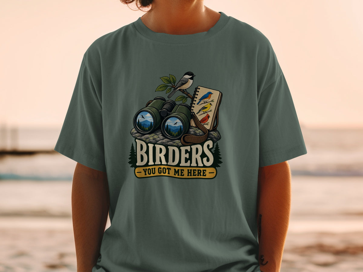 T-shirt graphic with binoculars, birds, and text "BIRDERS - YOU GOT ME HERE".