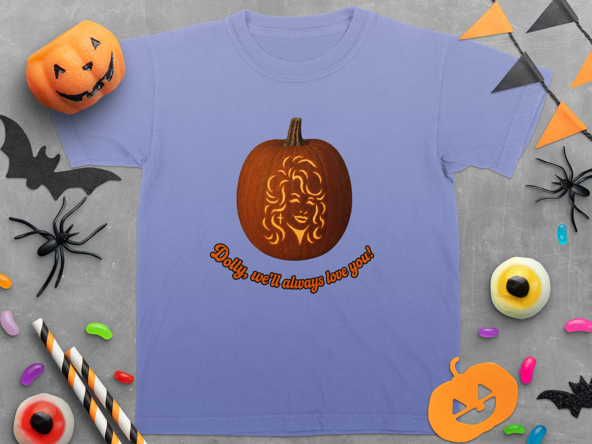 T-shirt with a carved pumpkin featuring a woman's face and text "Dolly, we'll always love you!".