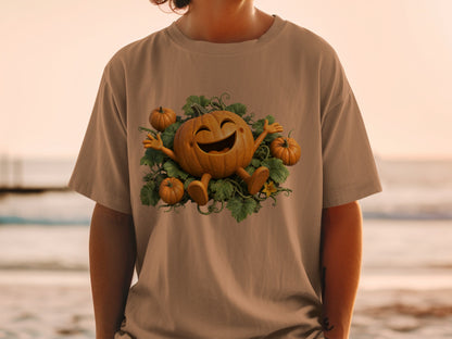 Happy cartoon pumpkin with vines and smaller pumpkins on a tan t-shirt.