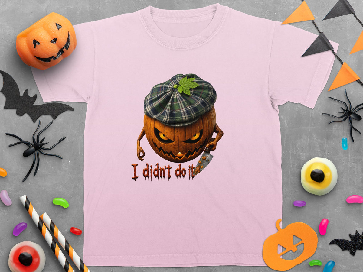 Pink t-shirt with a cartoon pumpkin wearing a plaid hat and holding a knife with text "I didn't do it".