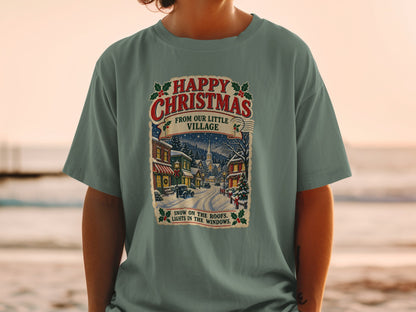 T-shirt with "Happy Christmas From Our Little Village" and snowy village scene.