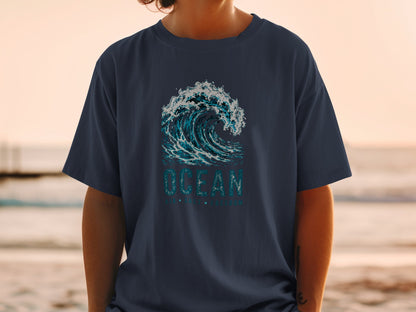 Navy t-shirt with a crashing blue wave and "OCEAN AIR SALT FREEDOM" text.