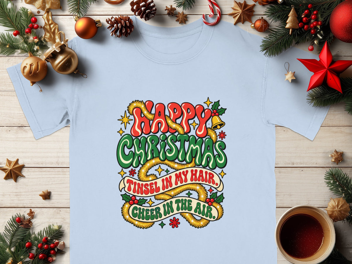 Light blue t-shirt with "Happy Christmas," "Tinsel in My Hair," and "Cheer in the Air" text.