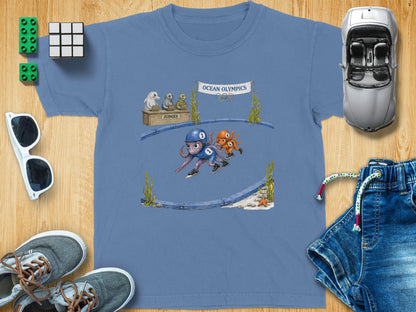 T-shirt featuring cartoon octopuses ice skating under an "Ocean Olympics" banner.