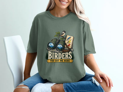 Green t-shirt with "Birders You Got Me Here" graphic featuring binoculars, birds, and notebook.