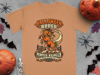 Orange t-shirt with Halloween Rodeo graphic featuring a pumpkin with a cowboy hat and lasso.
