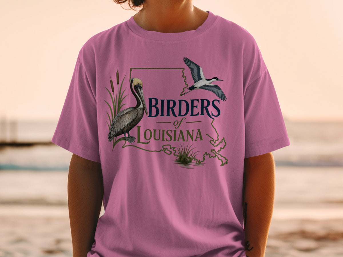 Pink t-shirt with "Birders of Louisiana" text, a pelican, and a flying bird.