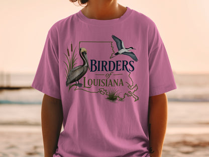 Pink t-shirt with "Birders of Louisiana" text, a pelican, and a flying bird.