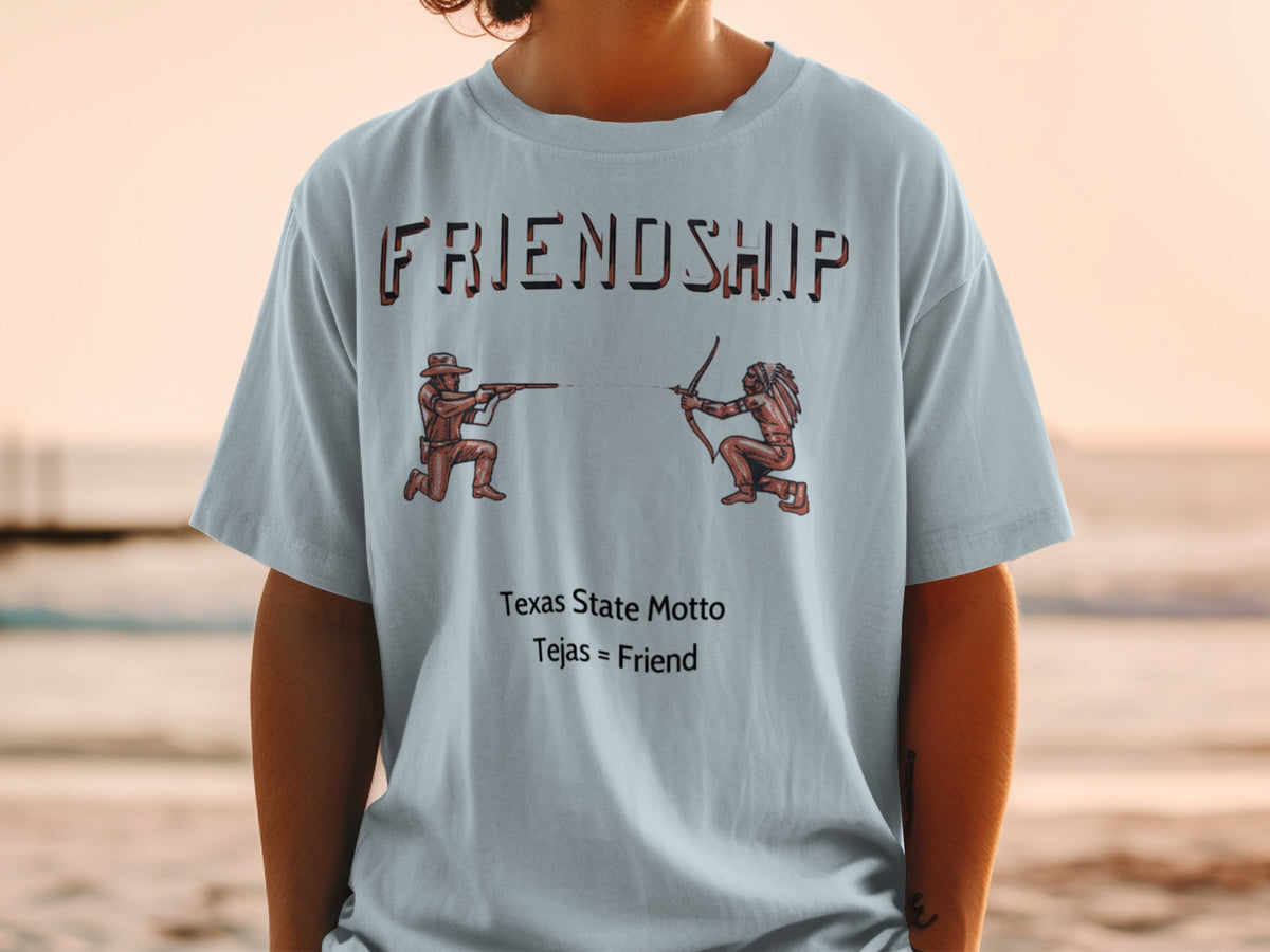 Light blue t-shirt with "FRIENDSHIP" text, cowboy and Native American figures, and "Tejas = Friend" text.