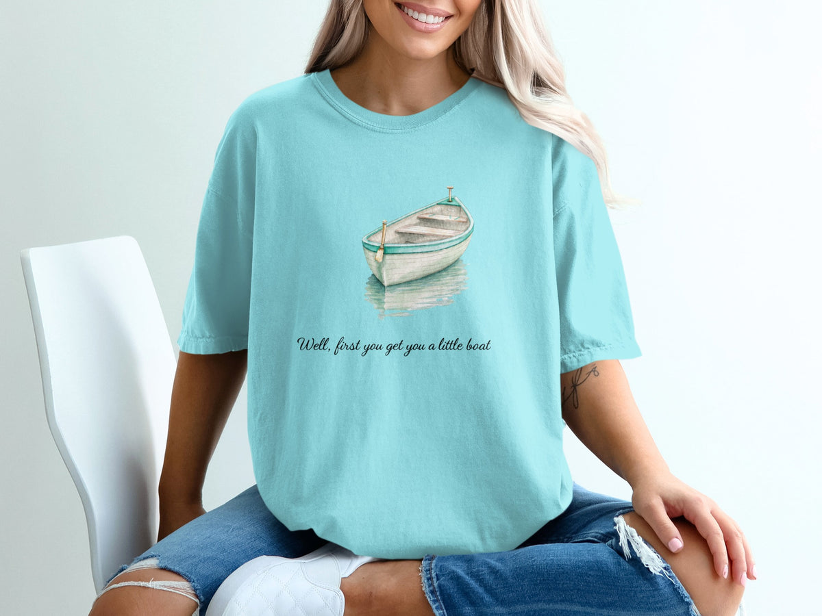 Aqua t-shirt with watercolor boat graphic and text: "Well, first you get you a little boat."