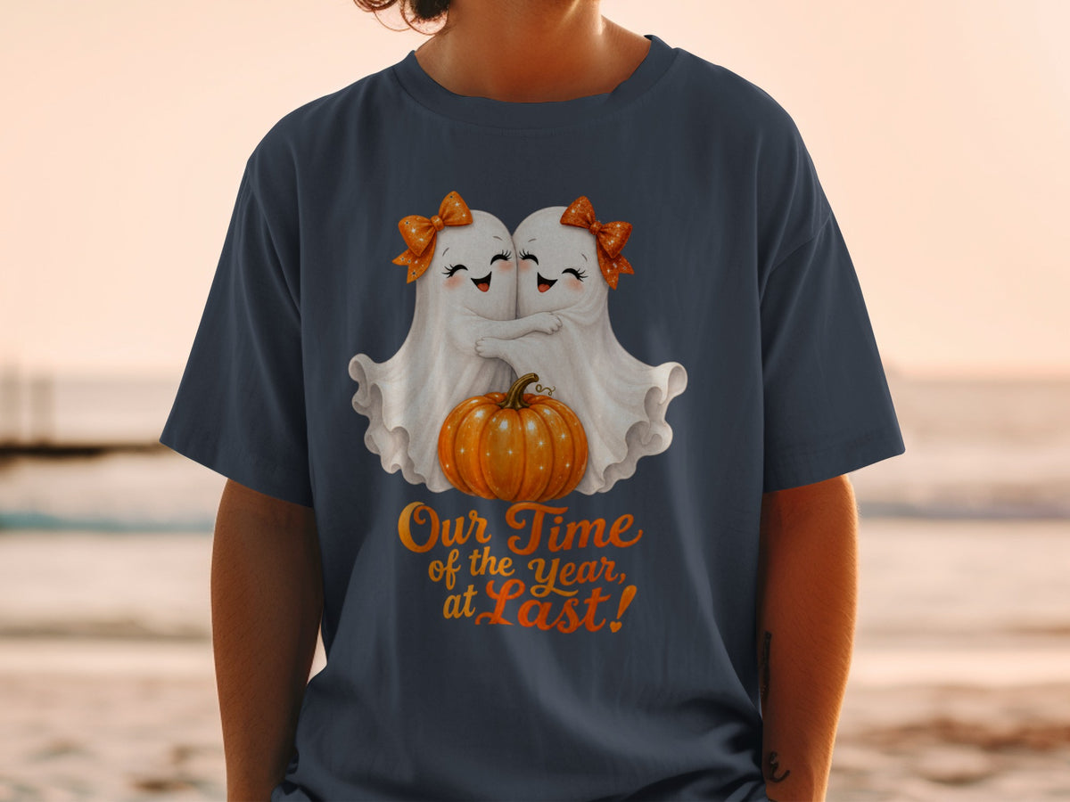 Two cartoon ghosts hug over a pumpkin, with text "Our Time of the Year, at Last!".