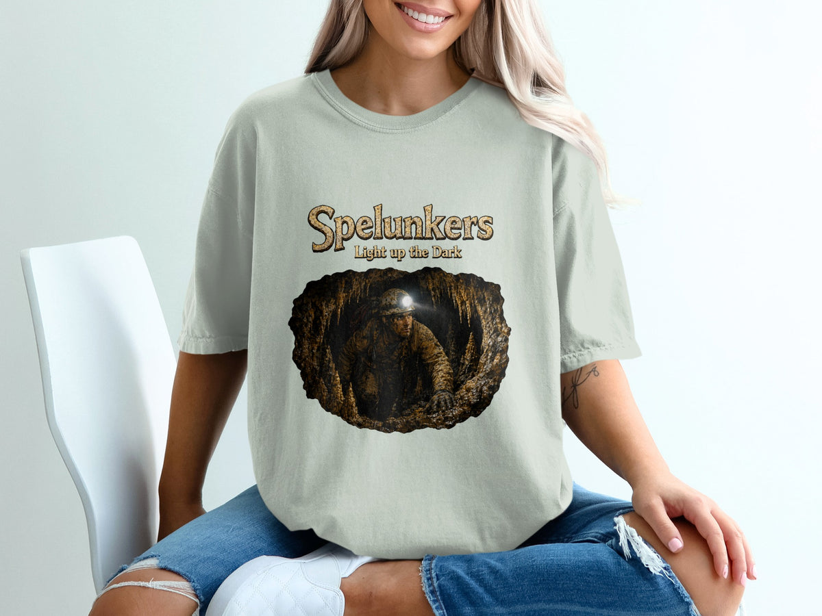 T-shirt with "Spelunkers light up the dark" text and cave explorer graphic.
