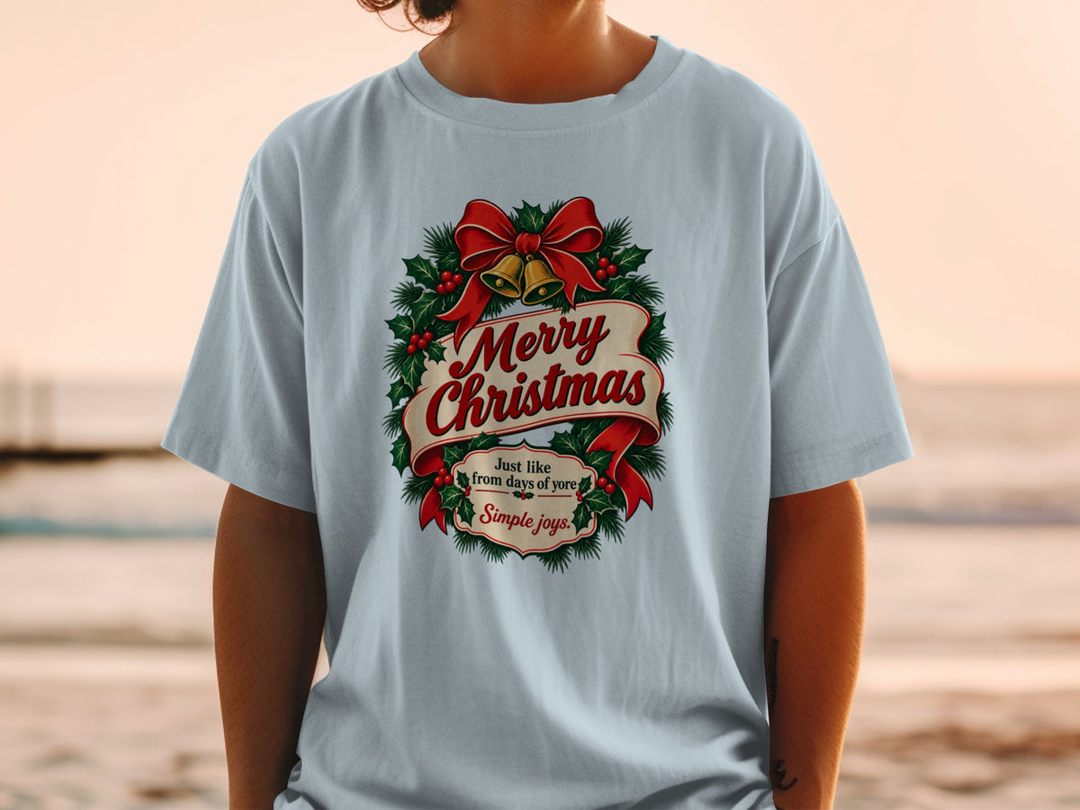Light blue t-shirt with "Merry Christmas" text, holly, bells, and bow graphic.