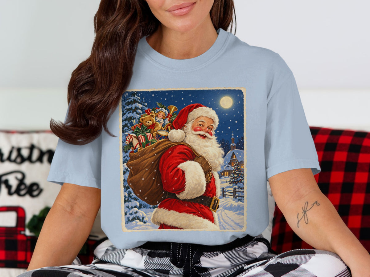Santa Claus carrying a sack of gifts in a snowy village scene at night.