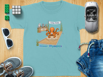 T-shirt with "Ocean Olympics" and octopus long jump cartoon.