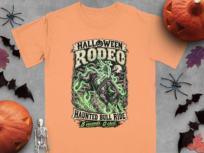 Orange t-shirt with "Halloween Rodeo Haunted Bull Ride 8 seconds. O chill." graphic.
