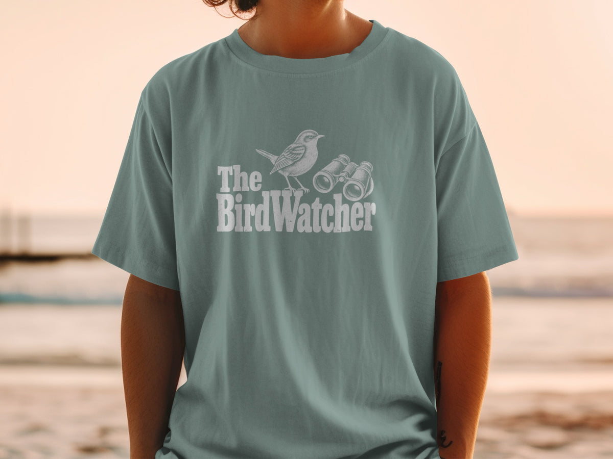 Gray t-shirt with "The BirdWatcher" text, bird, and binoculars graphic.