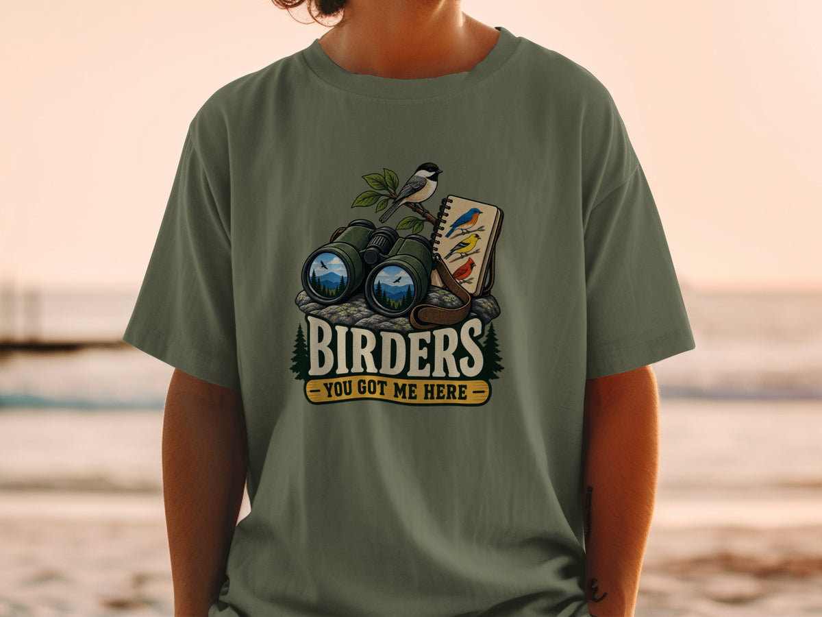 T-shirt graphic with binoculars, birds, and text "Birders - You Got Me Here".