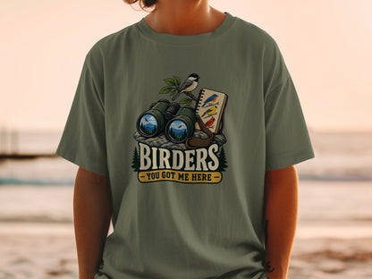 T-shirt graphic with binoculars, birds, and text "Birders - You Got Me Here".