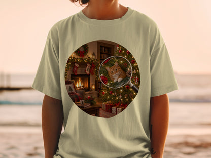 Magnified ginger cat peeks out from a Christmas tree on a t-shirt.