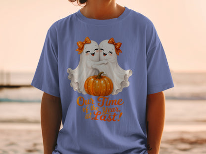 Two cute ghosts hug a pumpkin, with text "Our Time of the Year, at Last!"