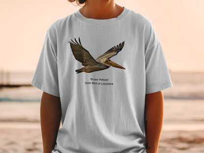T-shirt graphic of a brown pelican flying, with text "Brown Pelican State Bird of Louisiana".