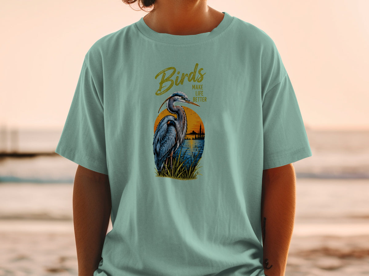 T-shirt graphic of a heron with text "Birds Make Life Better" at sunset.