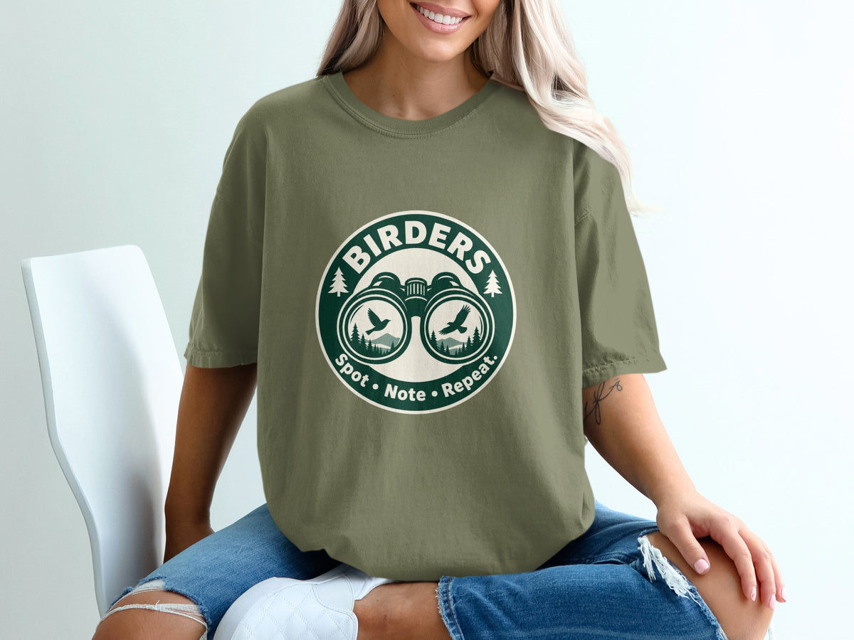 Green t-shirt with "BIRDERS Spot • Note • Repeat" text and binoculars graphic.