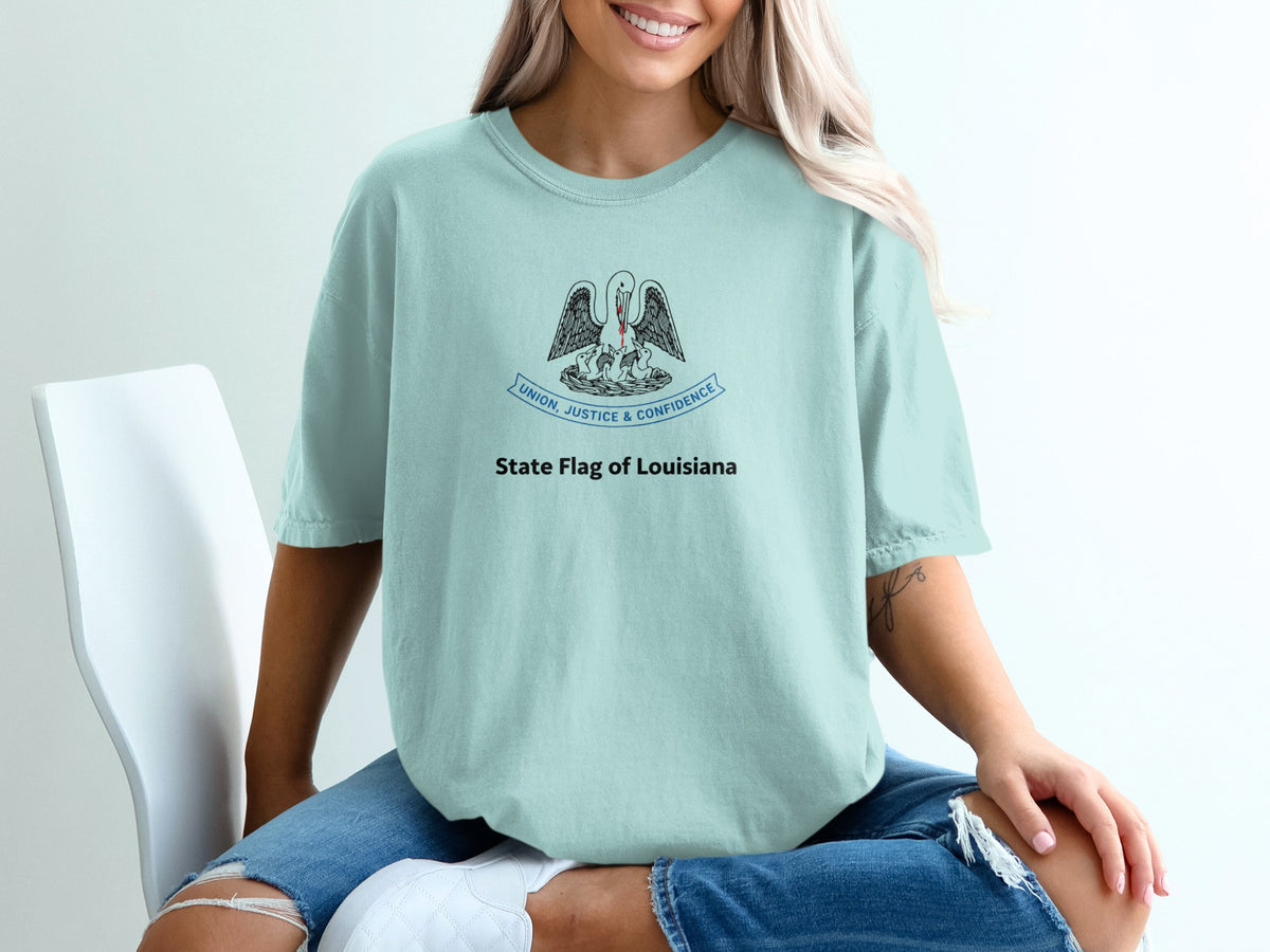 Light blue t-shirt with pelican and chicks design, "Union, Justice & Confidence".