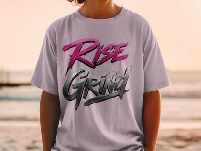 T-shirt with "Rise and Grind" text in metallic font on a person against a sunset background.