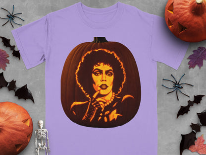 Light purple t-shirt featuring a lit jack-o-lantern carved with a portrait of Frank-N-Furter, surrounded by Halloween props.