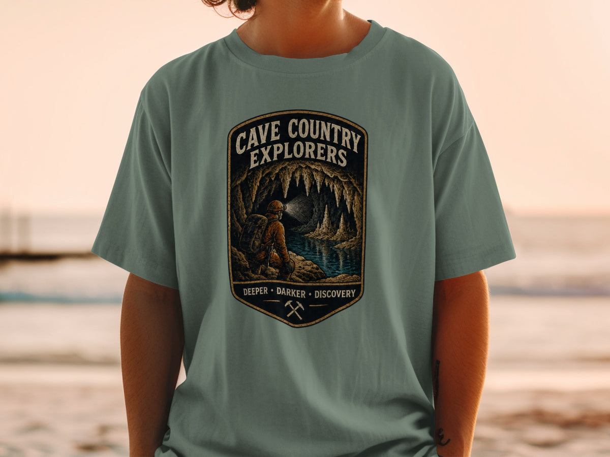 Cave Country Explorers graphic with speleologist exploring a cave with stalactites and underground lake.