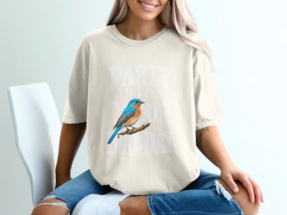 Cream t-shirt with blue bird and text: "PARTY LIKE IT'S YOUR BIRTHDAY".