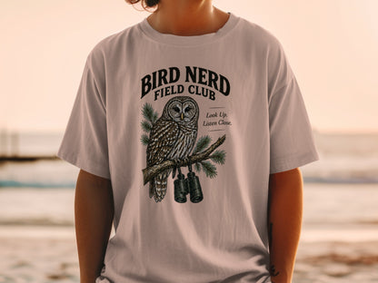 T-shirt graphic of an owl on a branch with binoculars, reads "Bird Nerd Field Club."