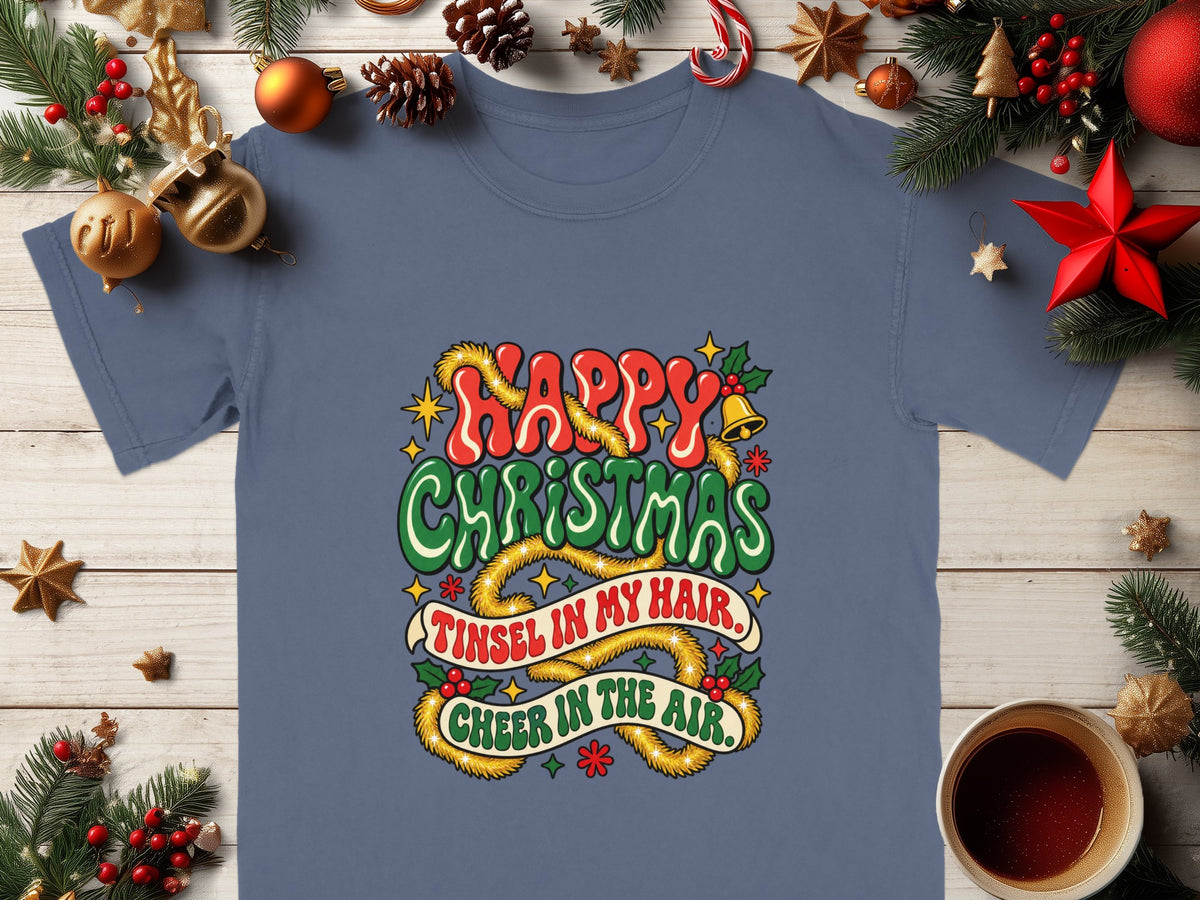 Blue t-shirt with "Happy Christmas, Tinsel in my hair, Cheer in the air." text.