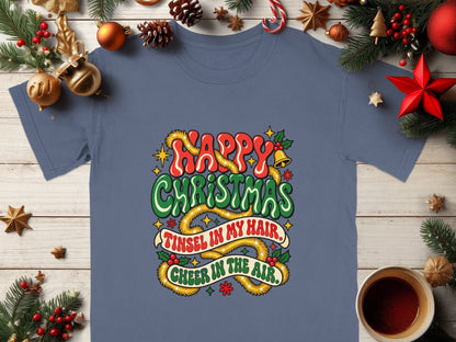 Blue t-shirt with "Happy Christmas, Tinsel in my hair, Cheer in the air." text.