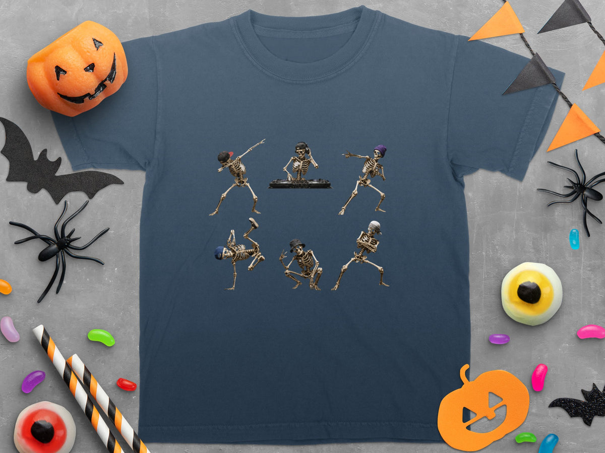 T-shirt with six dancing skeletons, one DJing, on a grey background with Halloween decorations.