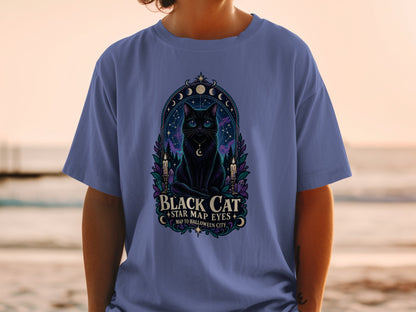 Black cat with star map eyes design on a blue t-shirt.
