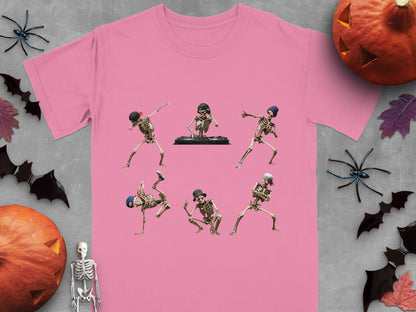 Dancing skeletons in various poses on a pink t-shirt, with Halloween decorations.
