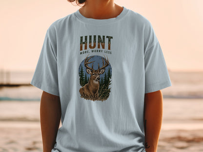 T-shirt graphic with deer, trees, and text "HUNT MORE, WORRY LESS".