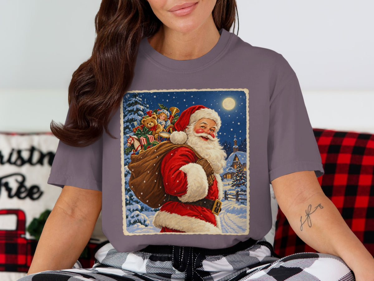 T-shirt with a vintage Santa Claus illustration carrying a sack of toys on a snowy night.