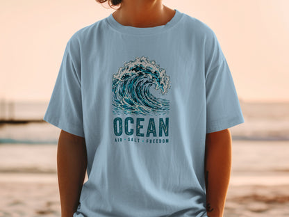 Light blue t-shirt with "OCEAN AIR SALT FREEDOM" text and wave graphic.