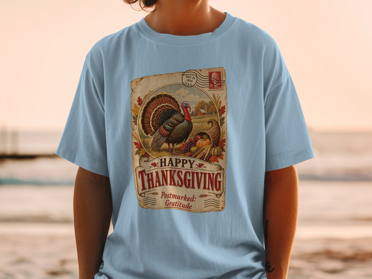 Light blue t-shirt with vintage Thanksgiving graphic: turkey, cornucopia, barn, and text.